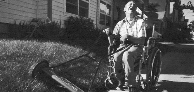 man mowing lawn in wheelchair